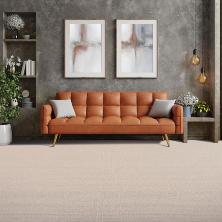 neutral light brown, tan patterned carpet in living area with leather orange sofa